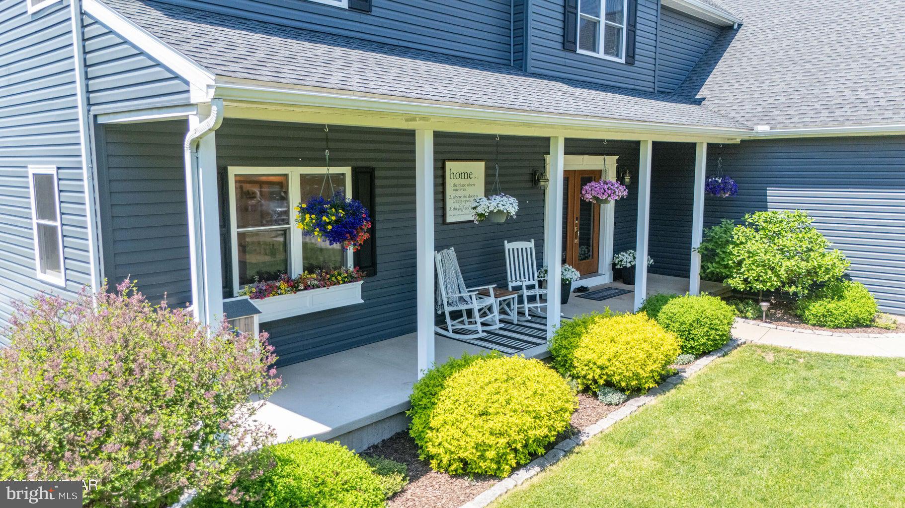 92 Easton Road Trout Run, PA 17771 - Photo 14 of 108 Charming porch with vibrant blooms.