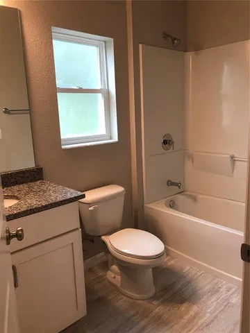 a white toilet sitting next to a bath tub shower