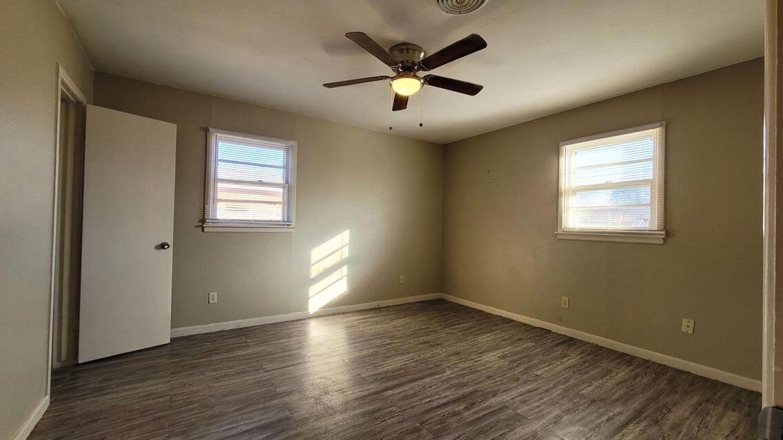 4429 31st Street Lubbock, TX 79410 - Photo 8 of 12 a view of empty room with wooden floor and fan