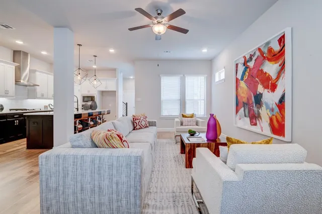 a living room with furniture and kitchen view