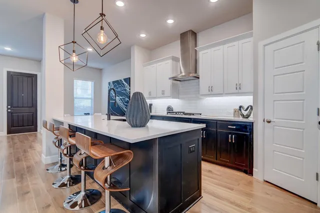 a kitchen with stainless steel appliances a sink stove and cabinets