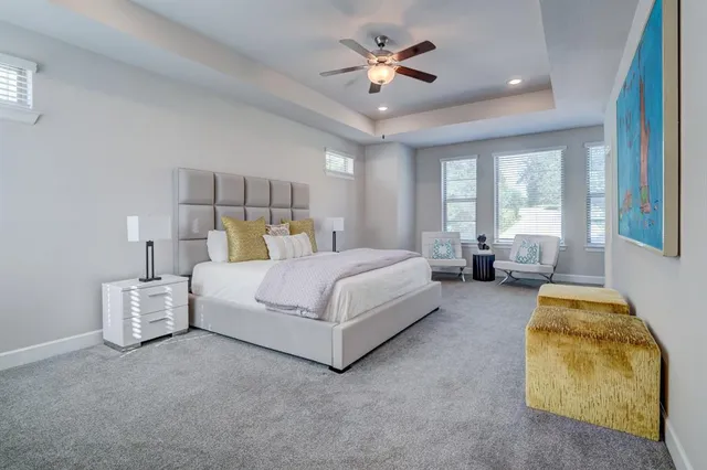 a spacious bedroom with a bed and a couch