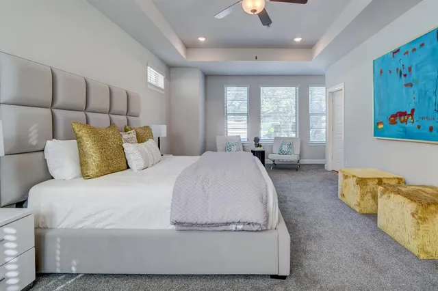 a spacious bedroom with a bed and couch