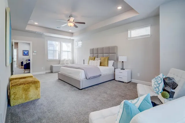 a spacious bedroom with a bed and a couch