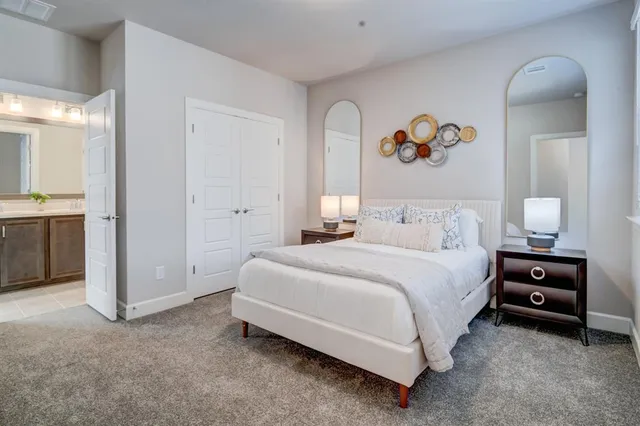 a bedroom with bed and painting on the wall