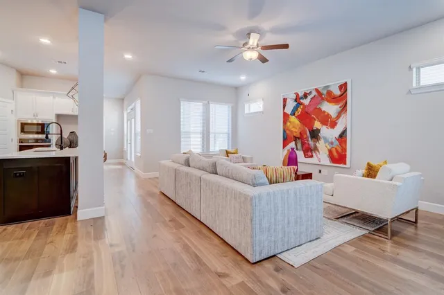 a living room with furniture and kitchen view