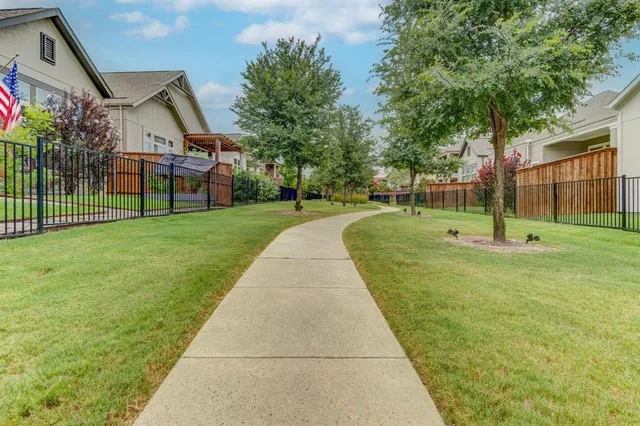 a view of a house with a big yard and large trees