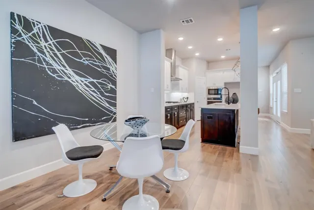 a kitchen with stainless steel appliances granite countertop a sink refrigerator and cabinets