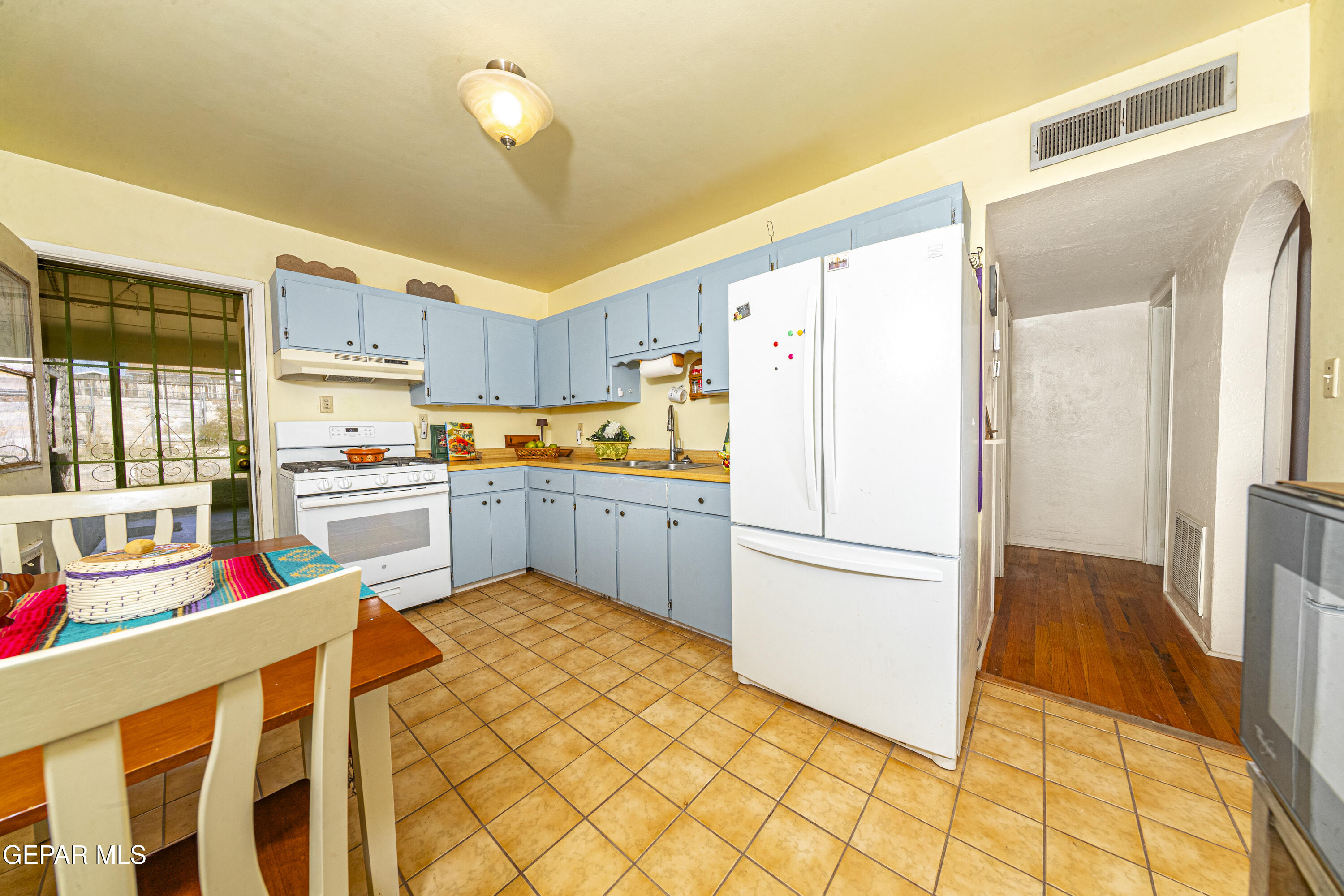 3329 Harrison Avenue El Paso, TX 79930 - Photo 17 of 38 a kitchen with a refrigerator a stove top oven and cabinets