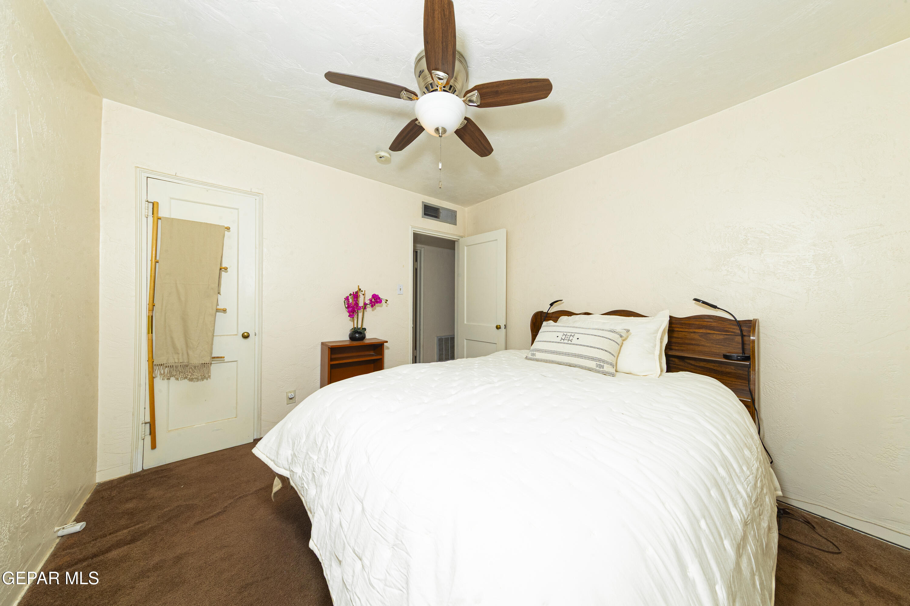 3329 Harrison Avenue El Paso, TX 79930 - Photo 21 of 38 a bedroom with a bed and a chandelier