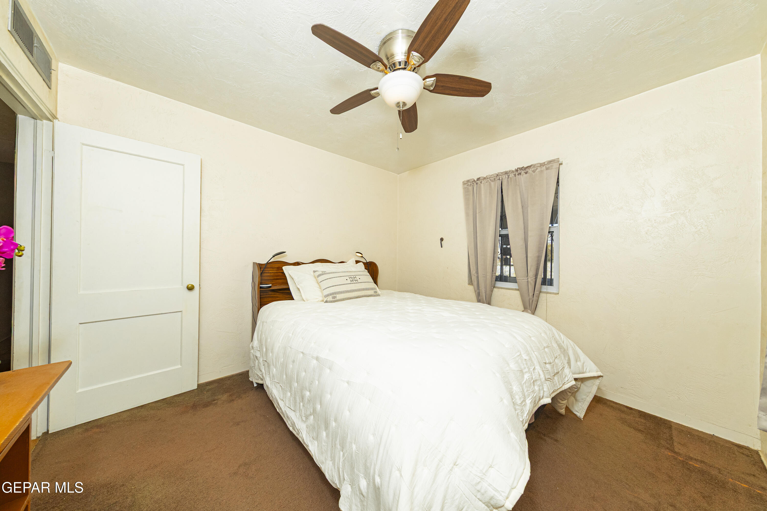 3329 Harrison Avenue El Paso, TX 79930 - Photo 22 of 38 a bedroom with a bed and a ceiling fan