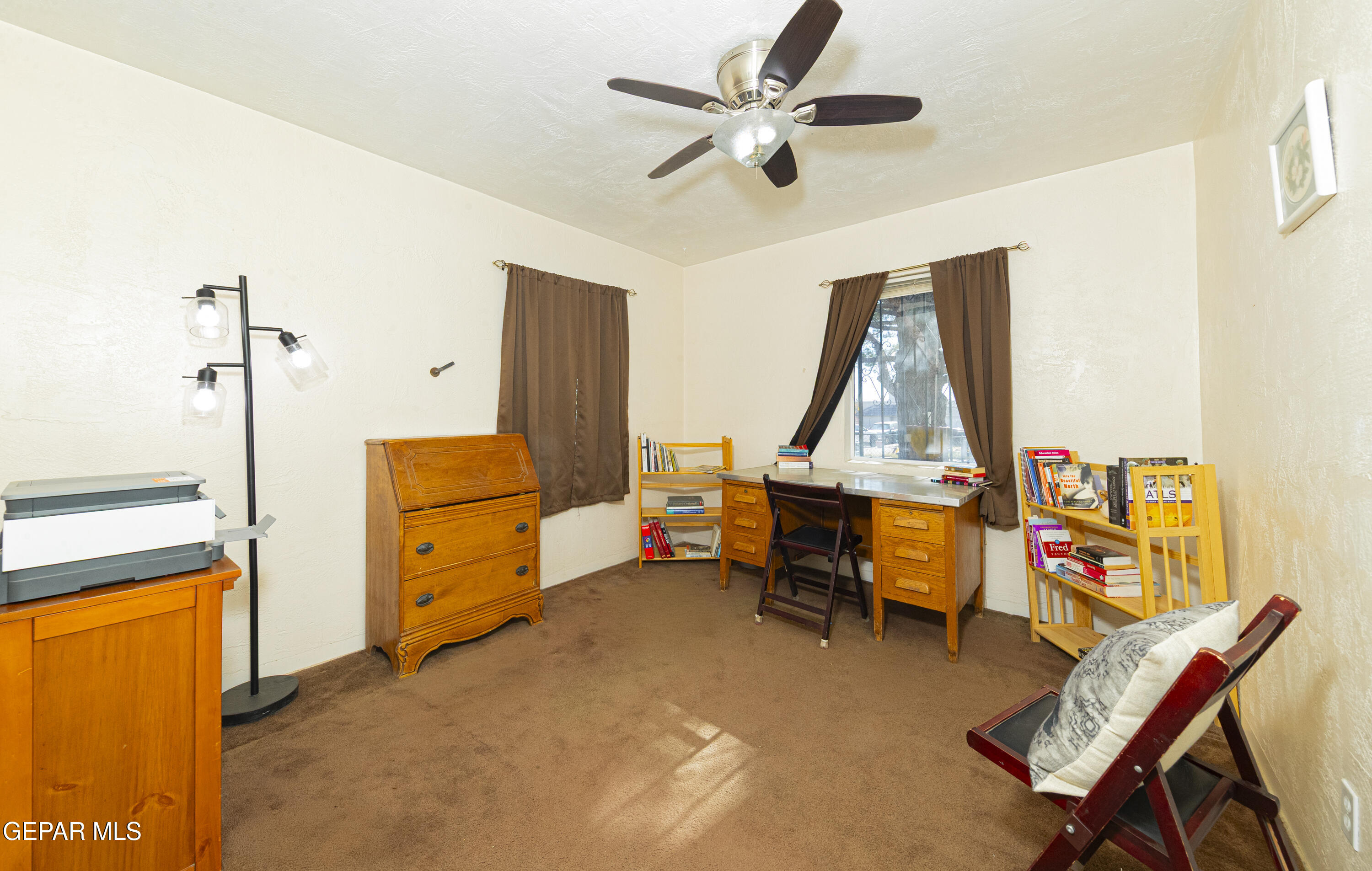 3329 Harrison Avenue El Paso, TX 79930 - Photo 24 of 38 a bedroom with a bed and a chandelier