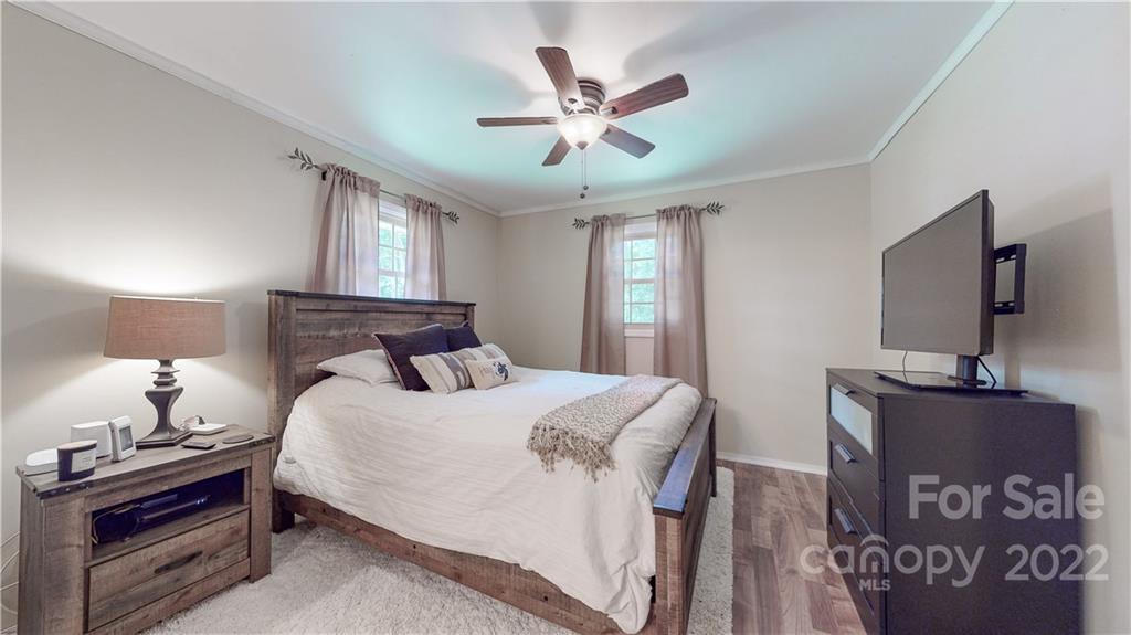6118 South Rocky River Road Monroe, NC 28112 - Photo 13 of 33 a bedroom with a bed and a flat screen tv