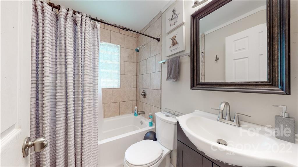 6118 South Rocky River Road Monroe, NC 28112 - Photo 16 of 33 a bathroom with a sink toilet and shower