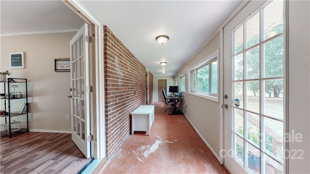 6118 South Rocky River Road Monroe, NC 28112 - Photo 18 of 33 a view of a hallway with wooden floor and stairs