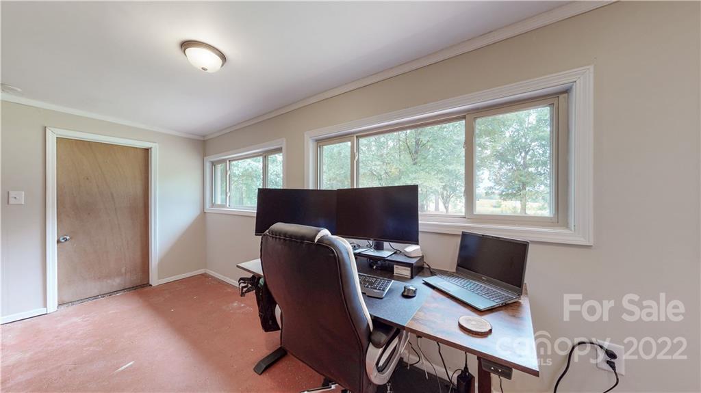 6118 South Rocky River Road Monroe, NC 28112 - Photo 19 of 33 a view of a workspace with furniture and a window