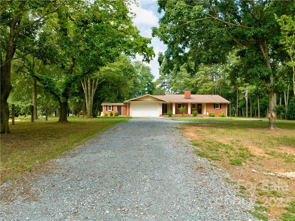 6118 South Rocky River Road Monroe, NC 28112 - Photo 2 of 33 a front view of a house with a yard