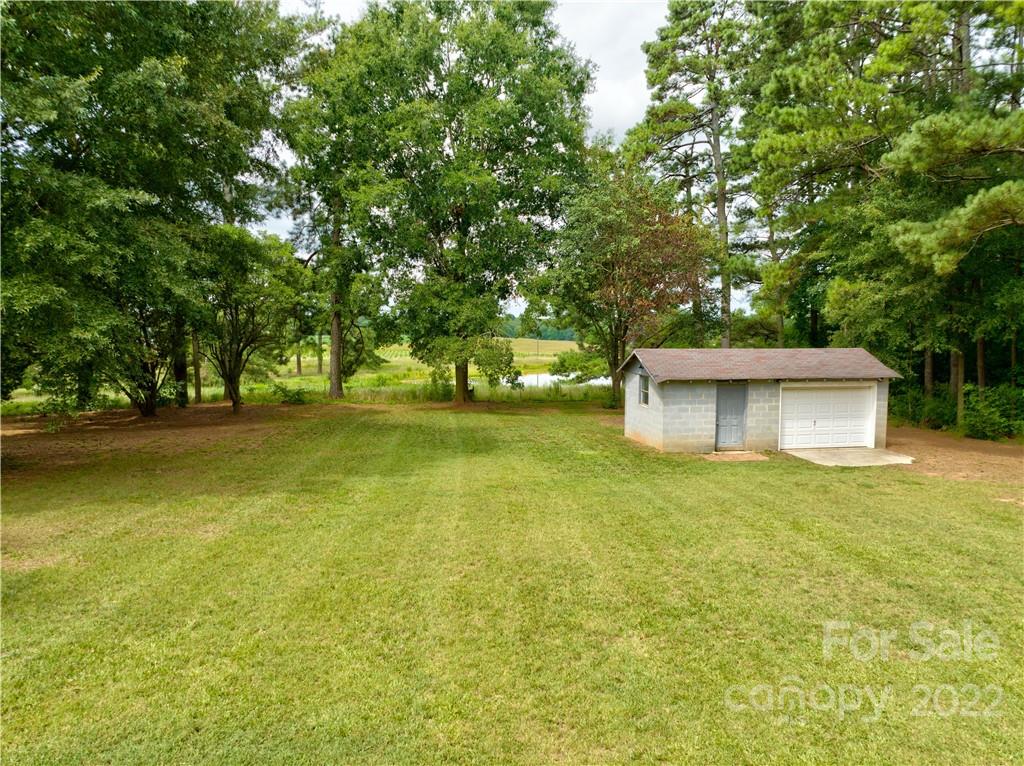 6118 South Rocky River Road Monroe, NC 28112 - Photo 26 of 33 a view of a tree in front of a house with a yard