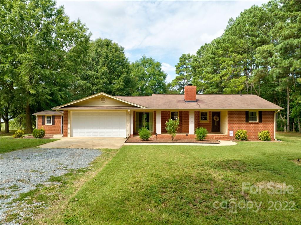 6118 South Rocky River Road Monroe, NC 28112 - Photo 3 of 33 a front view of a house with a garden