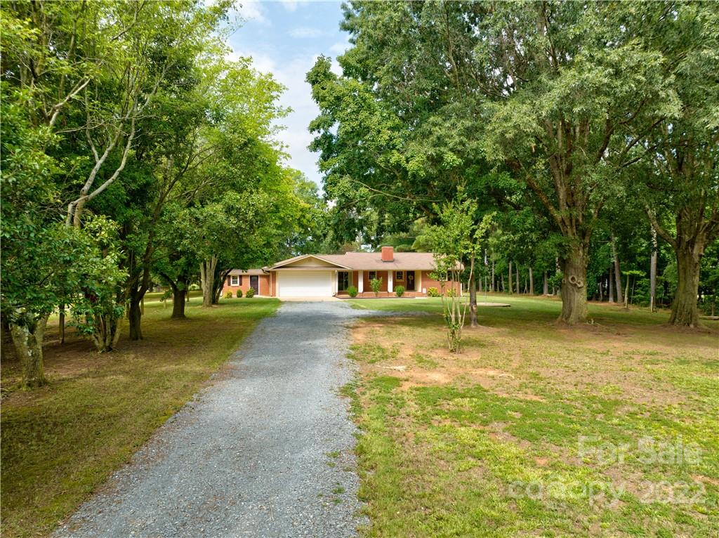 6118 South Rocky River Road Monroe, NC 28112 - Photo 31 of 33 a view of a house with a yard