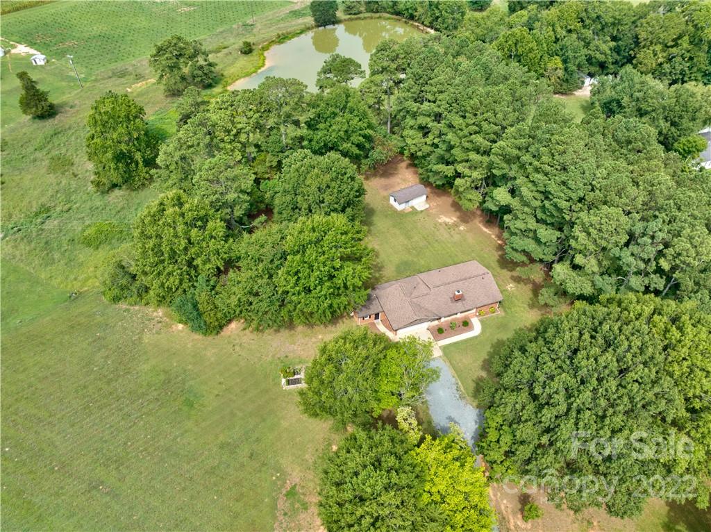 6118 South Rocky River Road Monroe, NC 28112 - Photo 4 of 33 an aerial view of residential house with outdoor space and trees all around