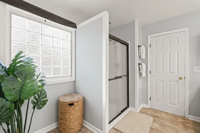 a view of hallway with livingroom and a potted plant