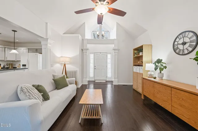 a living room with furniture and a chandelier