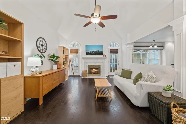 a living room with furniture fireplace and a window