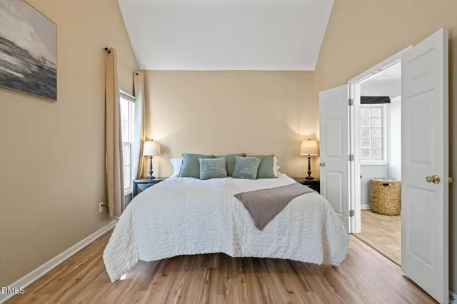 a bedroom with a bed and wooden floor