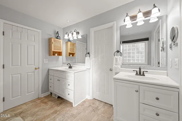 a spacious bathroom with a double vanity sink mirror and double