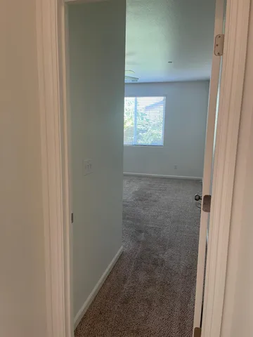 an empty room with a empty space and a ceiling fan