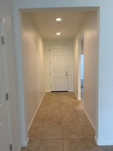 a view of hallway with a rug and a window
