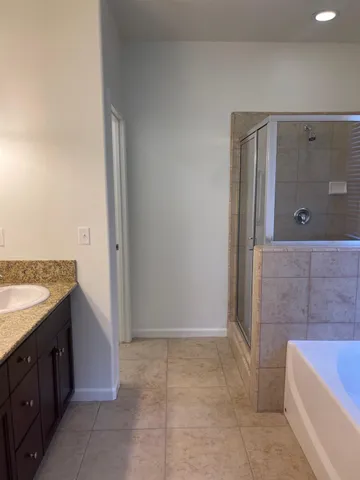 a bathroom with a bathtub and shower