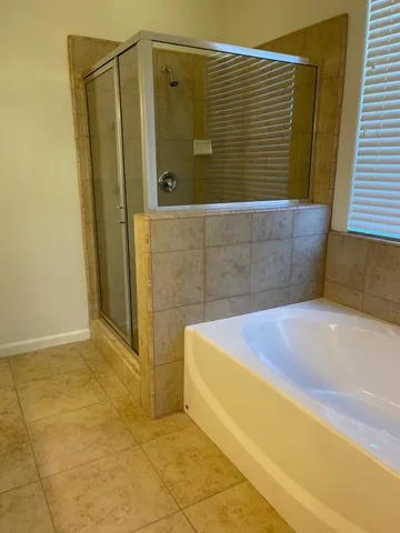 a bathroom with a granite countertop sink vanity and a mirror