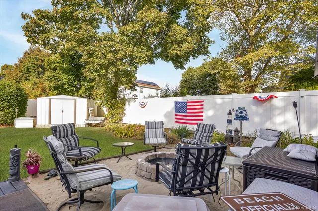 an outdoor sitting area with furniture and garden