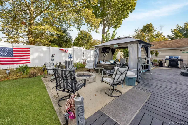a view of a patio with couches table and chairs and potted plants