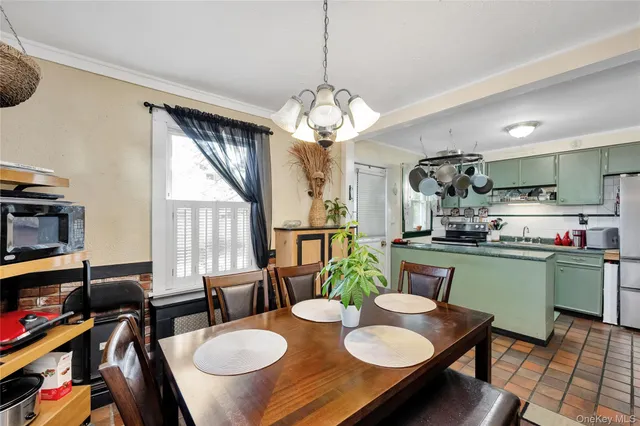 a view of a dining room with furniture and a chandelier