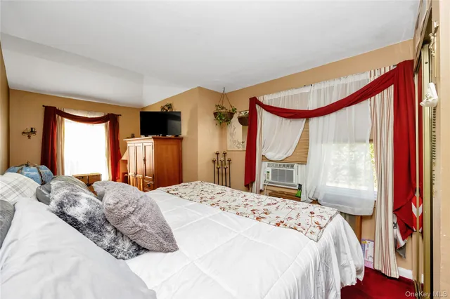 a bedroom with a large bed and a large window