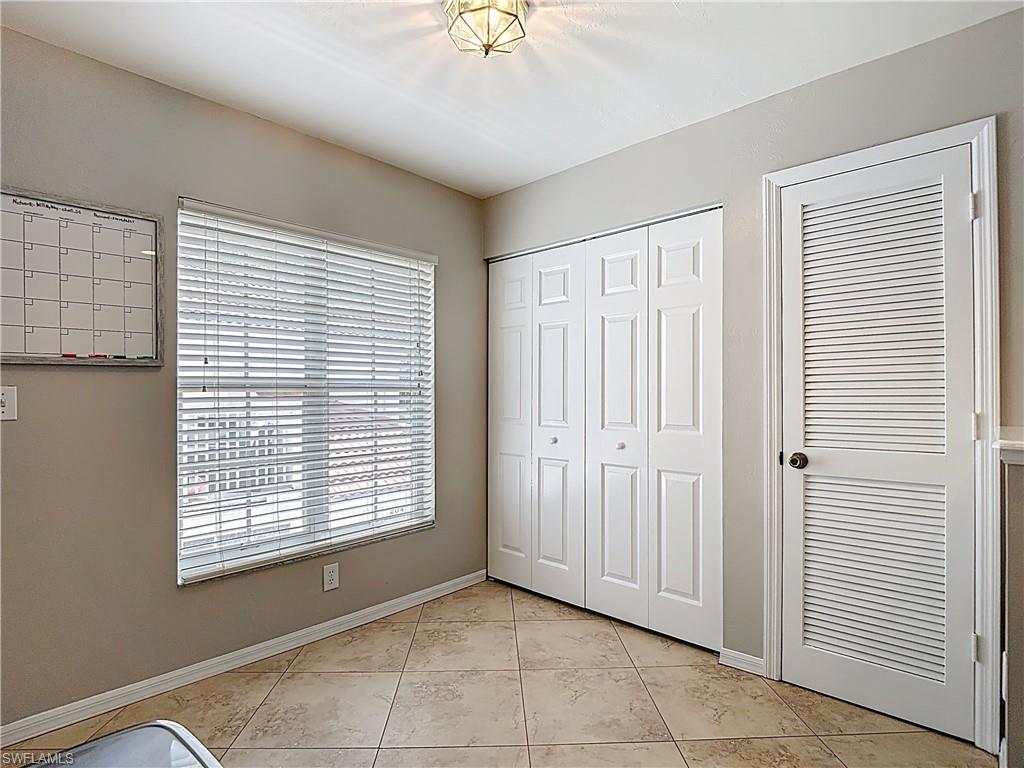 4970 Deerfield Way, Unit F203 Naples, FL 34110 - Photo 11 of 47 a view of an empty room with a window