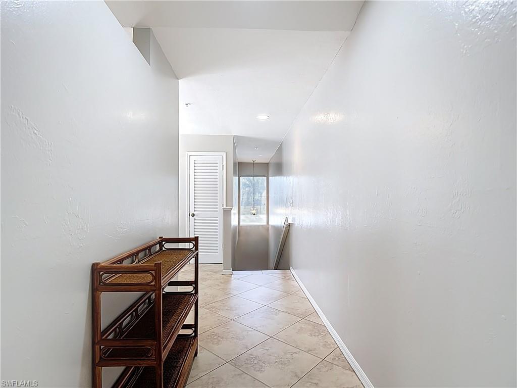 4970 Deerfield Way, Unit F203 Naples, FL 34110 - Photo 19 of 47 a view of a hallway with seating area