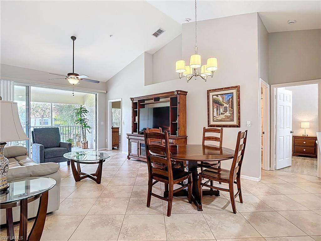 4970 Deerfield Way, Unit F203 Naples, FL 34110 - Photo 20 of 47 a view of a dining room with furniture window and outside view