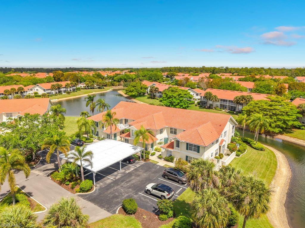 4970 Deerfield Way, Unit F203 Naples, FL 34110 - Photo 2 of 47 a view of a city with an ocean view