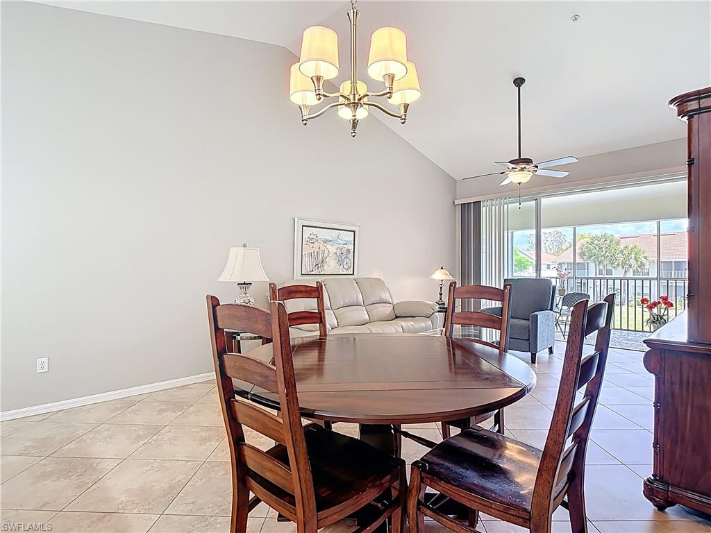 4970 Deerfield Way, Unit F203 Naples, FL 34110 - Photo 21 of 47 a view of a dining room with furniture wooden floor and chandelier