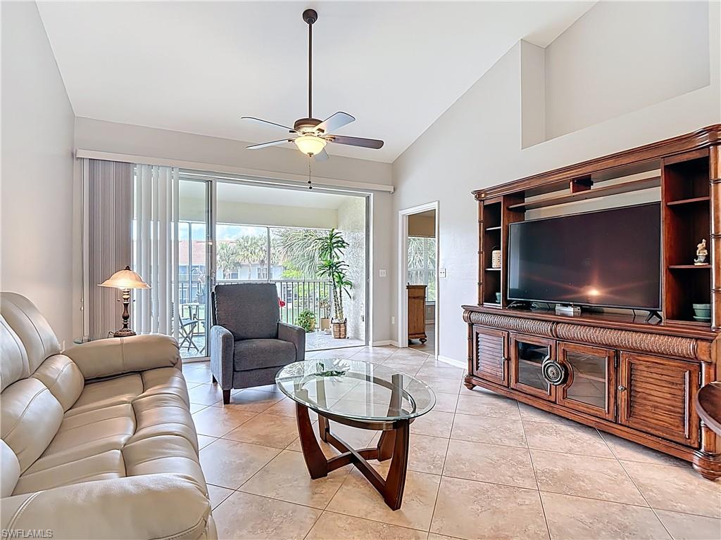 4970 Deerfield Way, Unit F203 Naples, FL 34110 - Photo 24 of 47 a living room with furniture and a flat screen tv