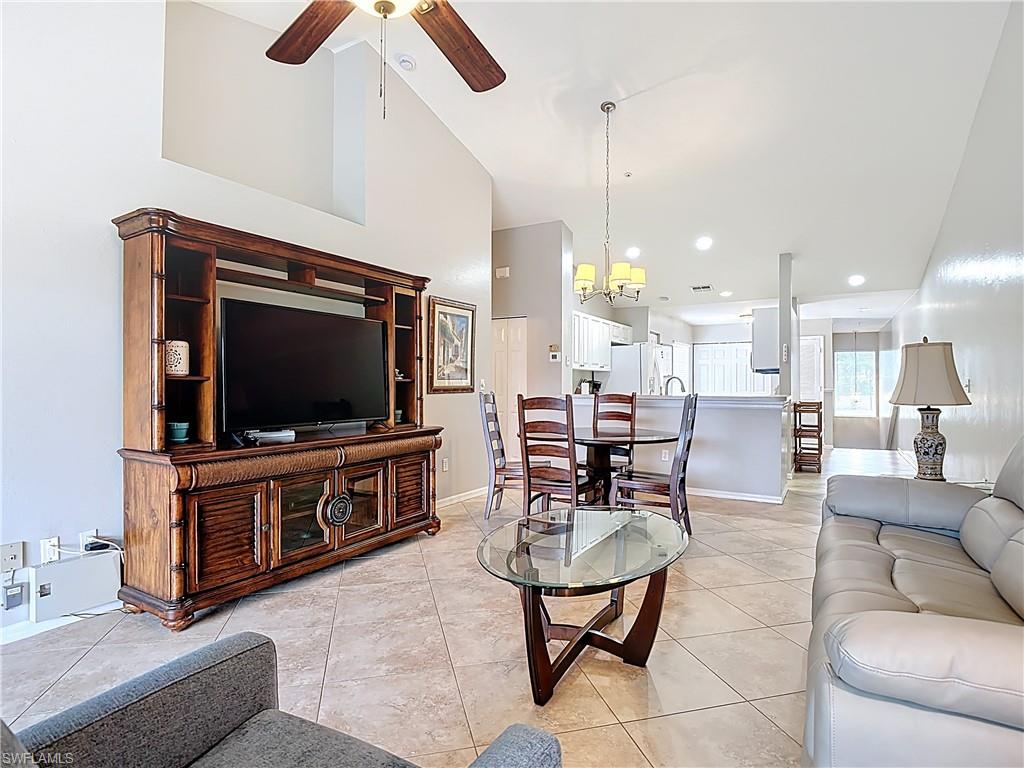 4970 Deerfield Way, Unit F203 Naples, FL 34110 - Photo 25 of 47 a living room with furniture and a flat screen tv