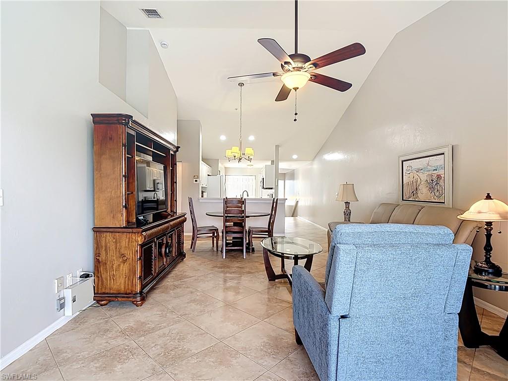 4970 Deerfield Way, Unit F203 Naples, FL 34110 - Photo 26 of 47 a living room with furniture and a flat screen tv