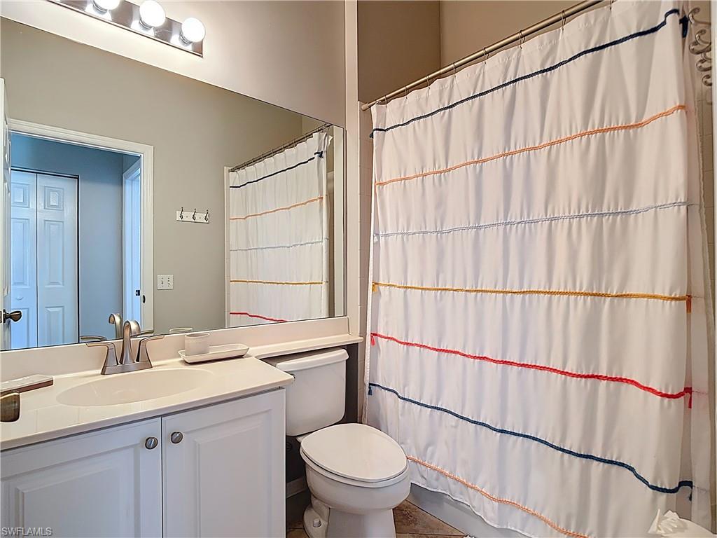 4970 Deerfield Way, Unit F203 Naples, FL 34110 - Photo 31 of 47 a bathroom with a sink a toilet and shower