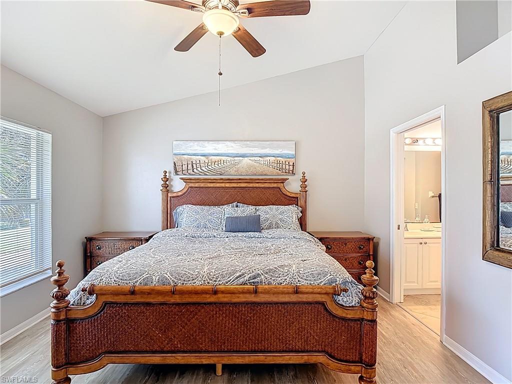 4970 Deerfield Way, Unit F203 Naples, FL 34110 - Photo 32 of 47 a bedroom with a bed and wooden floor