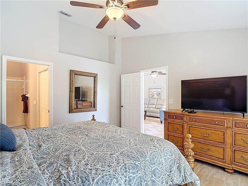4970 Deerfield Way, Unit F203 Naples, FL 34110 - Photo 34 of 47 a bedroom with a bed and furniture