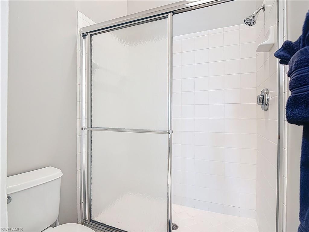 4970 Deerfield Way, Unit F203 Naples, FL 34110 - Photo 37 of 47 a bathroom with a shower and a toilet